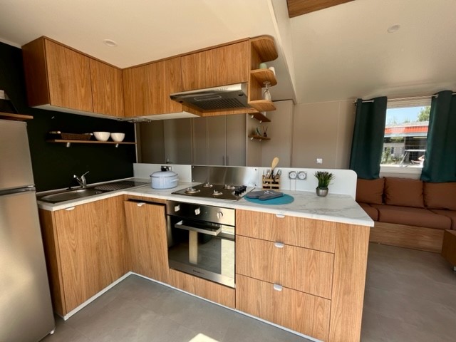 Cuisine moderne mobil-home premium Les Charmettes La Palmyre — équipement complet, four, micro-ondes, plaques gaz